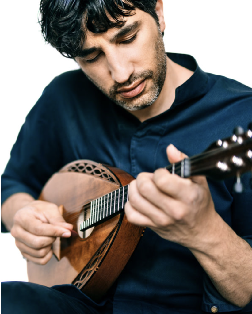 image of Avi Avital playing the mandolin, focused and calm